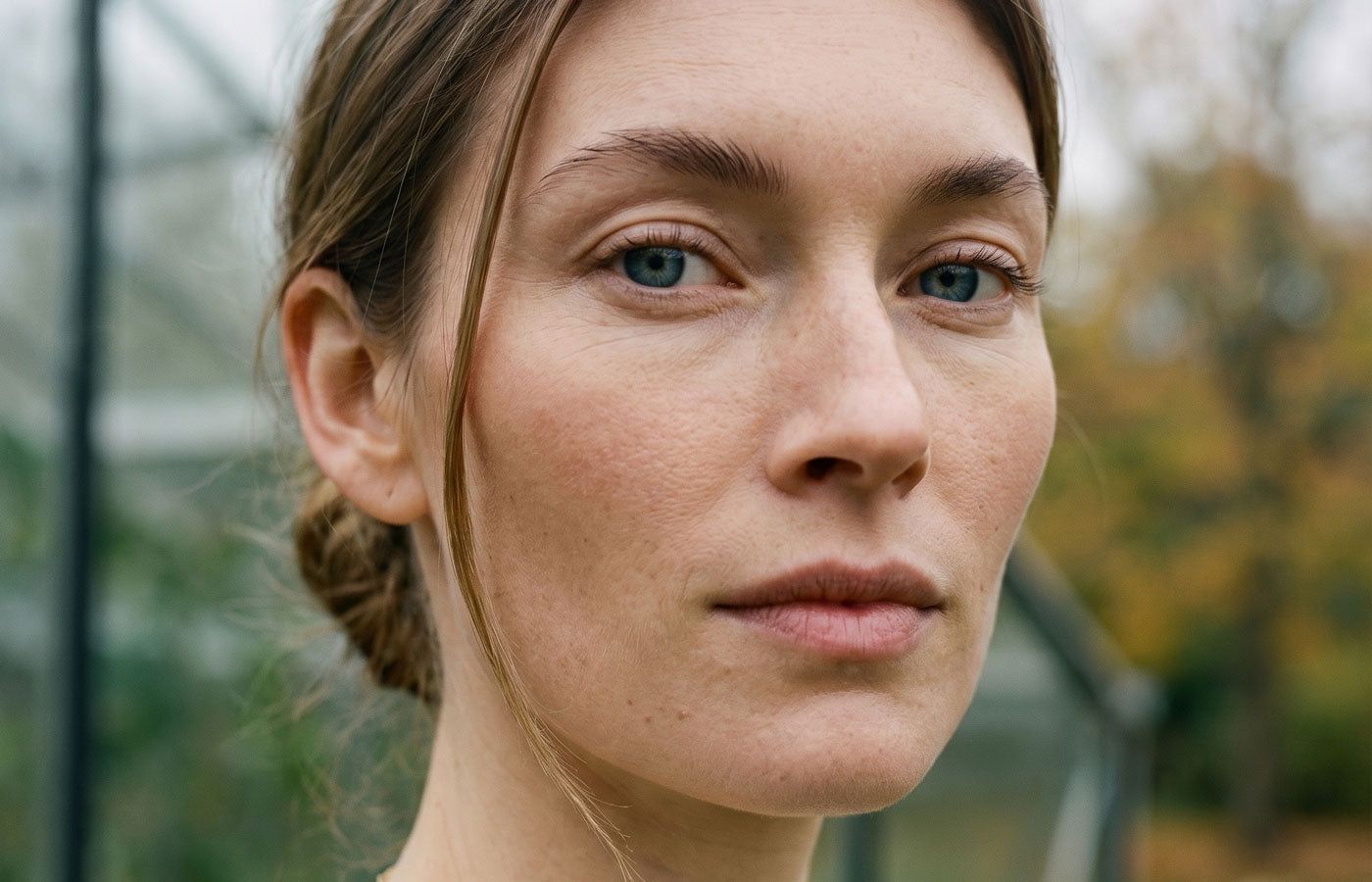 Image of a woman staring a camera she's in her 40's enjoying the morning air.