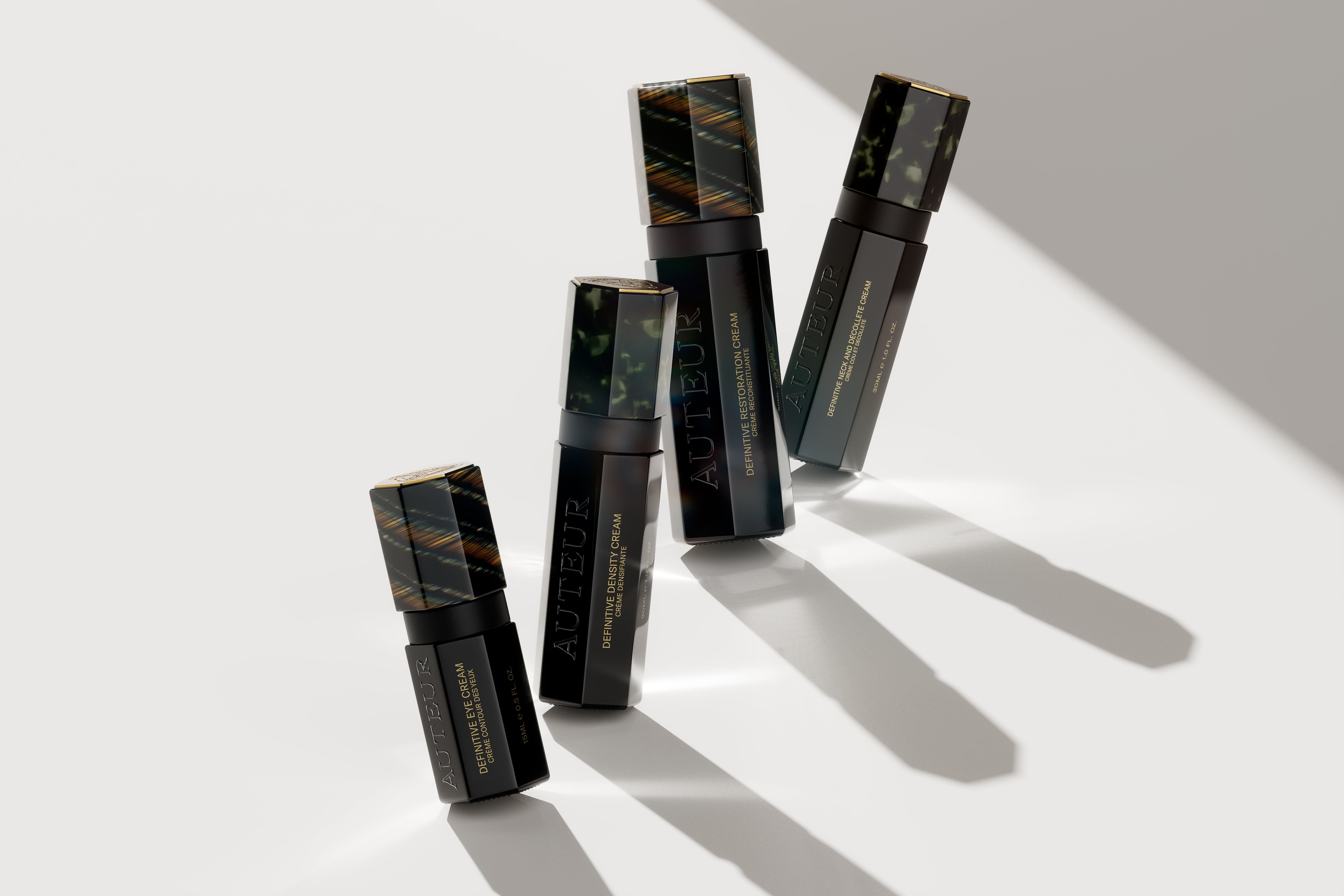 AUTEUR skincare Definitive Collection Creams I Black Bottles on Stone Backdrop