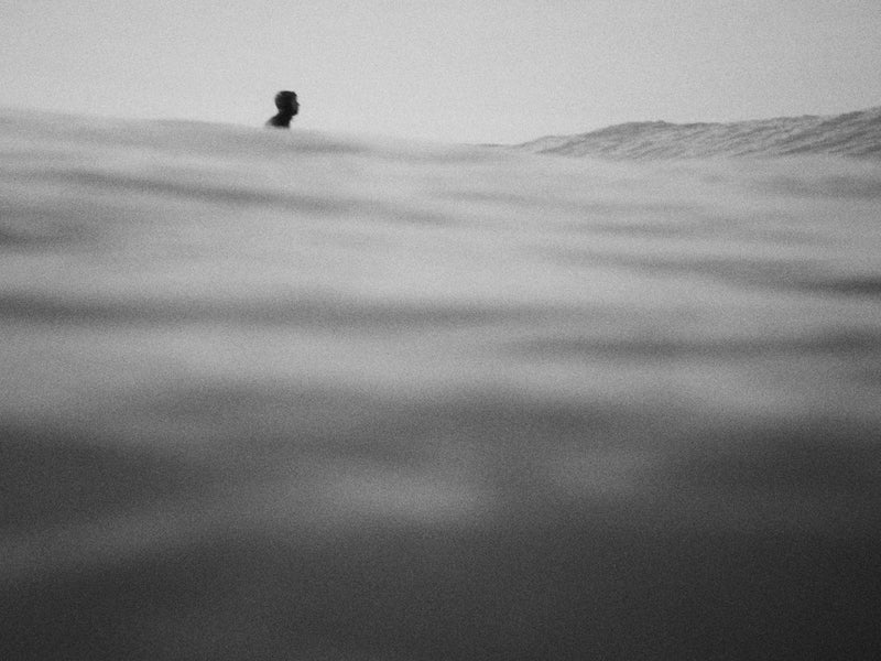 Person standing on a snowy landscape with a minimalistic approach