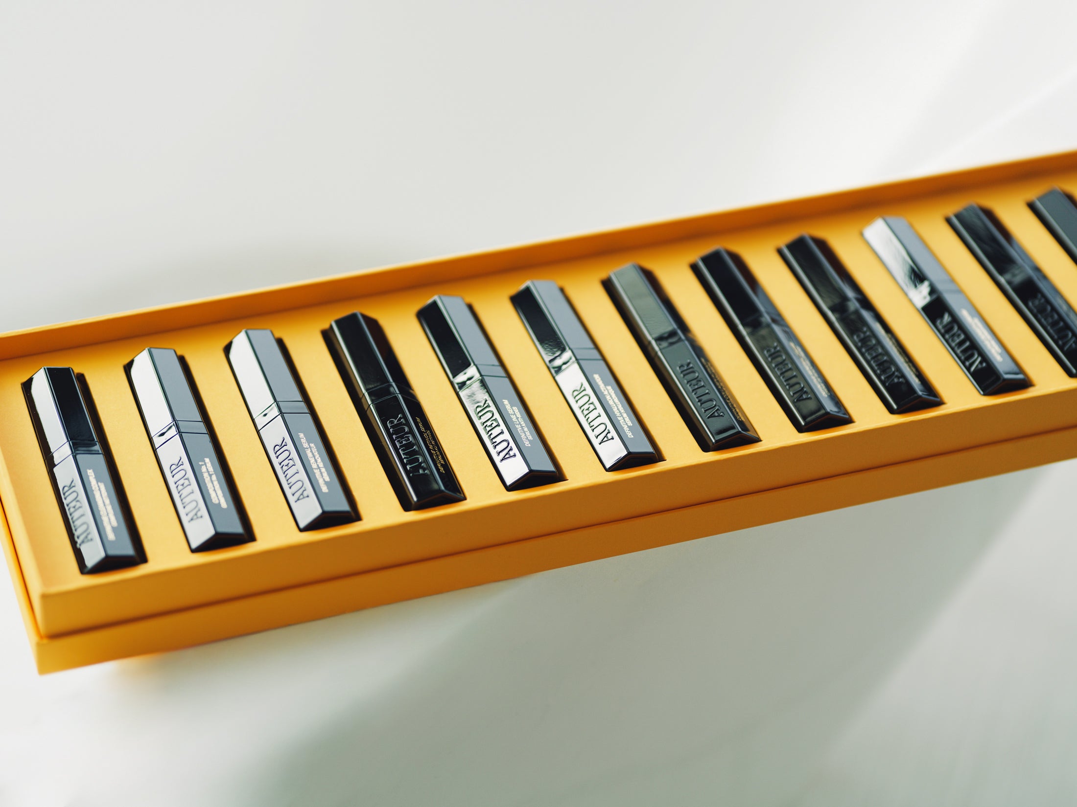 13 piece Auteur-collectors set of black and silver skin-care  in a yellow case on a white background