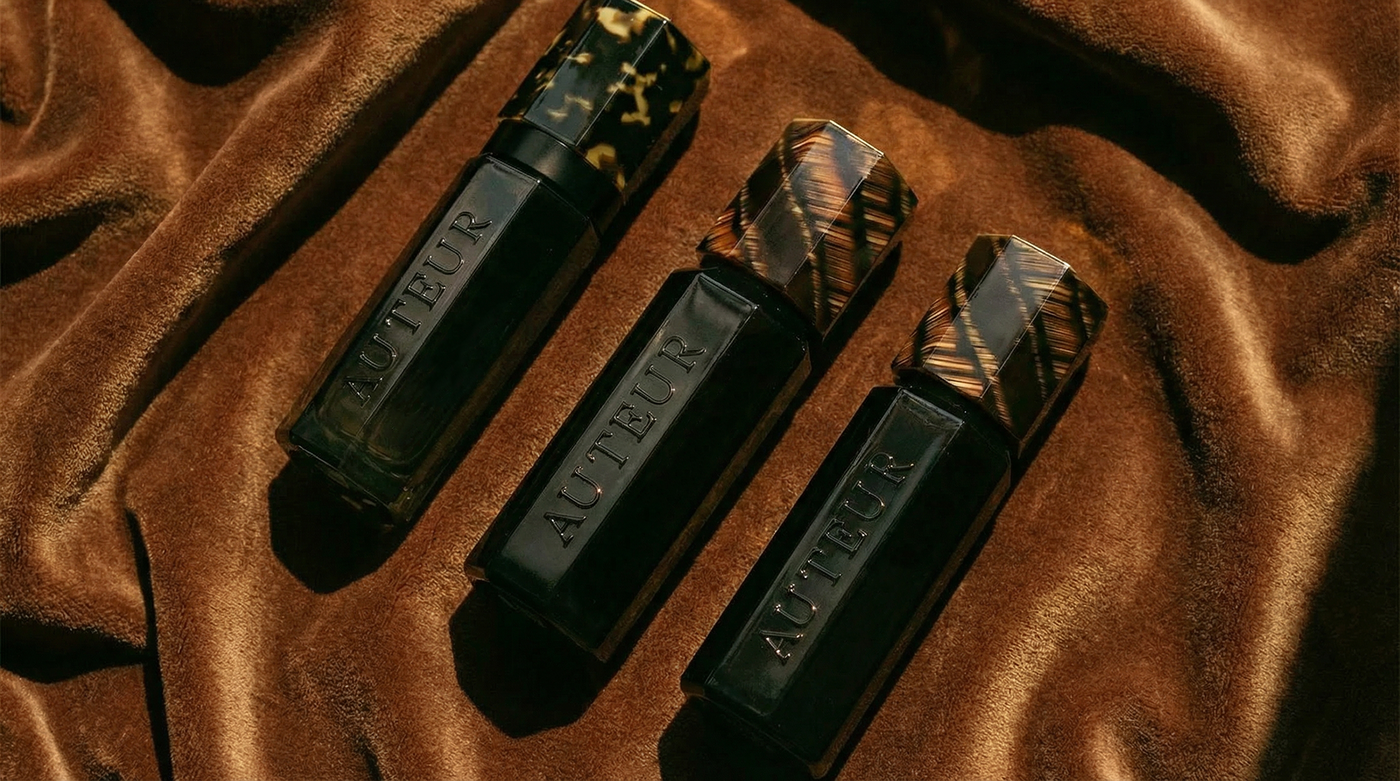 AUTEUR The Evening Order — three Definitive bottles on bronze satin