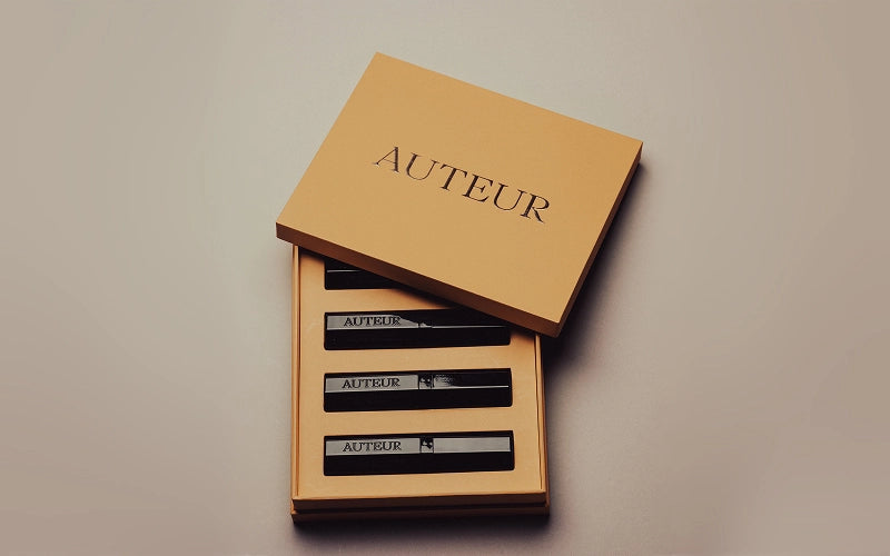Brown box with 'Auteur' branding on a beige background